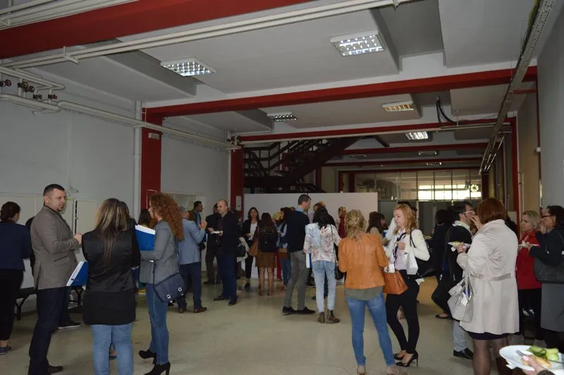 Conversation and networking during the break, in the space beside the hall