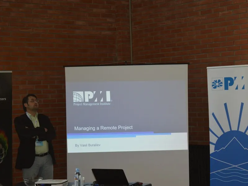 A speaker listening with folded arms next to the slide "Managing a Remote Project"