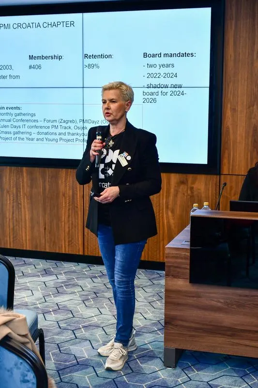 A speaker from the PMI chapter in Croatia presenting her chapter's membership figures
